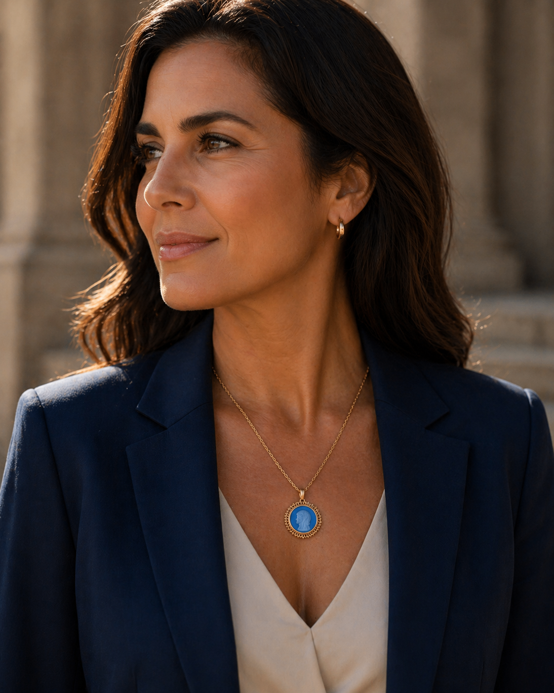 Model wearing the Water as Healing Virgin Mary medallion in a Fleur de Lis frame